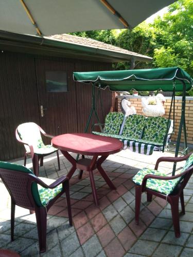 a picnic table and chairs on a patio at IN Pavlović in Banja Koviljača