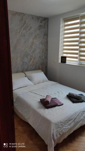a bedroom with a bed with two towels on it at Apartment Central Park in Gabrovo