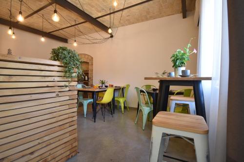 a restaurant with tables and chairs and a wooden wall at Al Faro Bianco B&B e Residence con parcheggio in Vasto