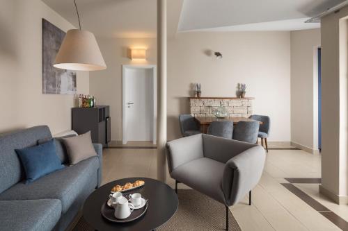 a living room with a couch and chairs and a table at Istrian Villas Plava Laguna in Umag