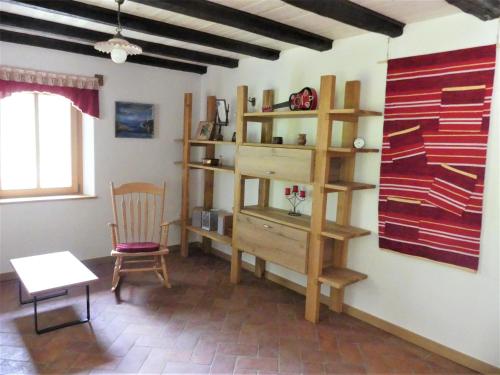 Zimmer mit einem Schreibtisch, einem Stuhl und einem Regal in der Unterkunft Hiša ob potoku in Avče