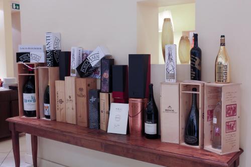 a bunch of wine bottles sitting on a wooden shelf at Hotel Touring in Fiorano Modenese
