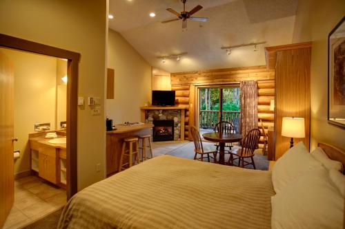 a bedroom with a bed and a kitchen and a table at Tigh-Na-Mara Seaside Spa Resort in Parksville