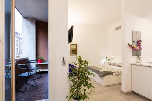 a small apartment with a bedroom and a bed and a desk at Queen of Brera - San Marco 1 in Milan