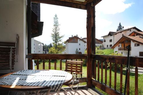 a view from the balcony of a house with a table at Schweizerhof Drescher in Lenzerheide