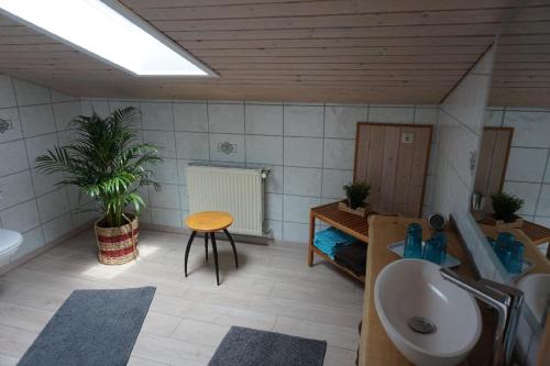 a bathroom with a sink and a toilet and a table at Ferienwohnung Weindl Lucia in Kollnburg