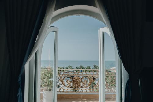 ventana abierta con vistas a un balcón en Paris Hotel Bình Thuận en Tuy Phong