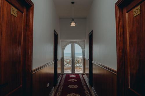 a hallway with an open door with a view at Paris Hotel Bình Thuận in Tuy Phong
