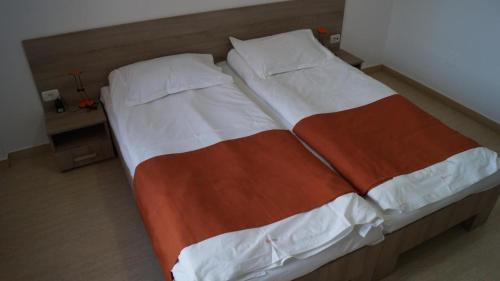 a large bed in a small room with at HOTEL BOURBON Vama Veche in Vama Veche