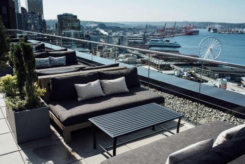 a living room filled with furniture next to a river at Thompson Seattle in Seattle
