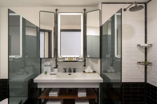 a bathroom with a sink and a shower at Thompson Seattle, by Hyatt in Seattle