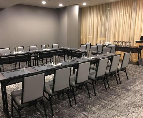 a group of tables and chairs in a room at Thompson Seattle, by Hyatt in Seattle