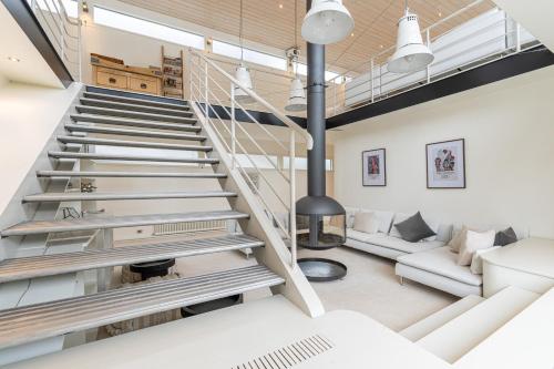 a staircase leading up to a living room with a fireplace at Charming houseboat featuring a sauna in London