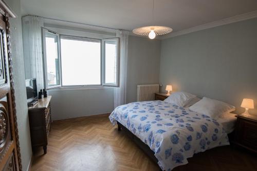 - une chambre avec un lit et une grande fenêtre dans l'établissement La Mouette, à Cancale