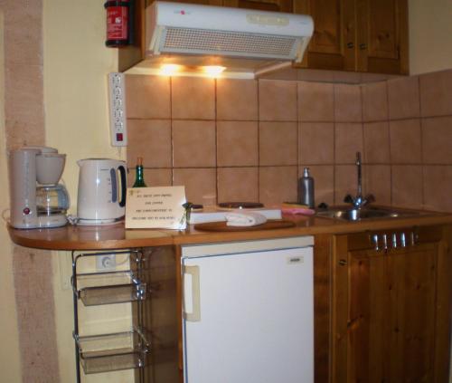 a kitchen counter with a sink and a microwave at Palazzo di Pietro in Chania Town