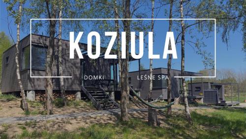 a house in the woods with the words kzula at Koziula - Domki na Kaszubach in Przywidz