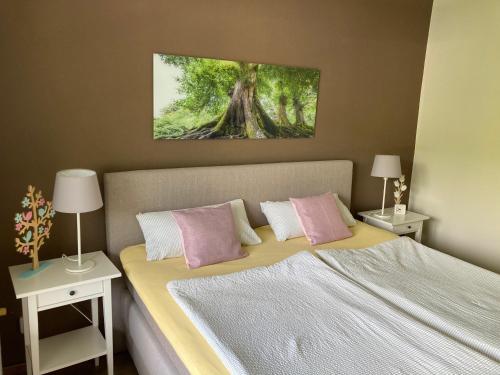 a bedroom with a bed with two tables and two lamps at Ferienwohnung von Damm in Bad Harzburg
