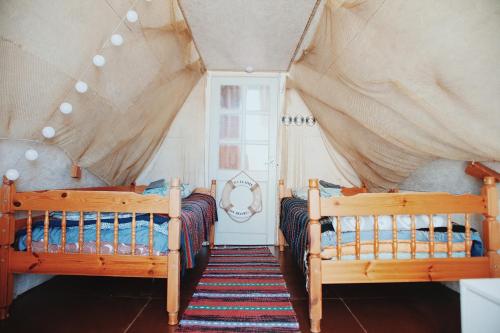 a bedroom with two beds and a window at Kihnu home - Sepa talu in Rootsiküla