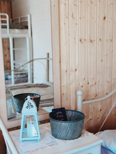 a room with two baskets and a stool on a table at Kihnu home - Sepa talu in Rootsiküla