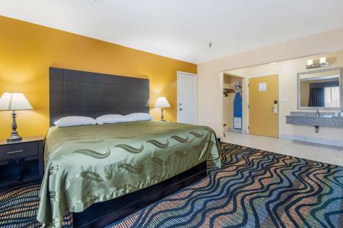 a hotel room with a large bed and a bathroom at Equality Inn in Rockford