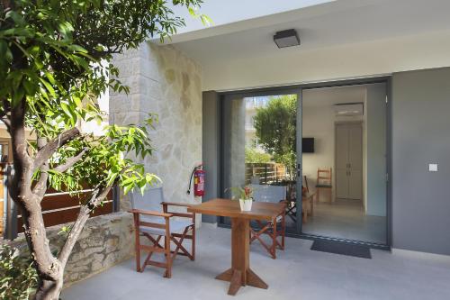 a glass extension to a house with a wooden table at Terpsis Estate in Chania Town