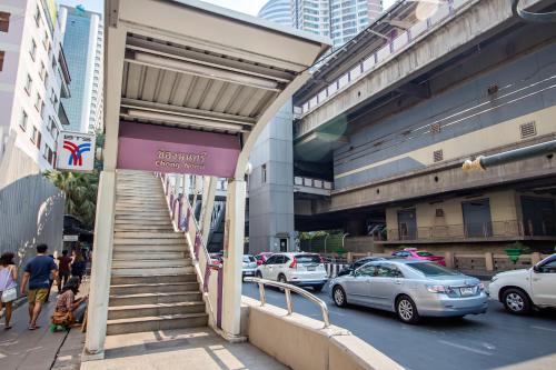 a building with a staircase on the side of a city street at Holiday Inn Express Bangkok Sathorn by IHG in Bangkok