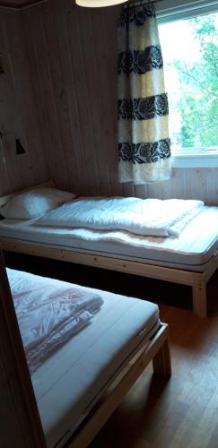 Säng eller sängar i ett rum på Fossheim Two-Bedroom Cottage