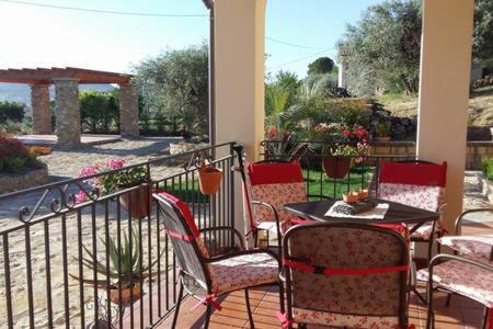a patio with a table and chairs on a balcony at Villa Russo in Caltanissetta