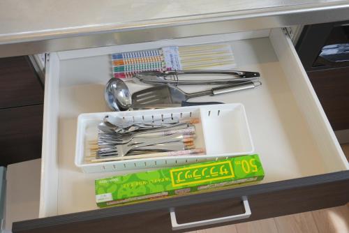 a drawer filled with utensils on a shelf at Private House Sakura in Fujikawaguchiko