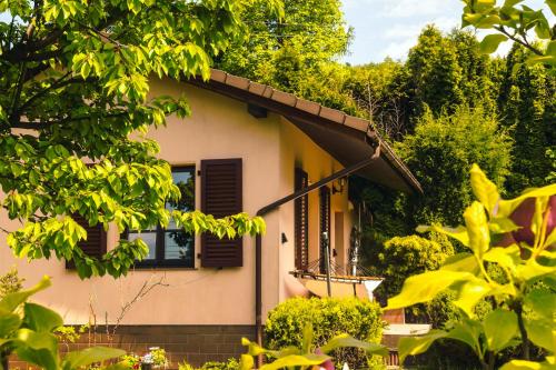 a small house with a window and trees at Sielankowy domek w górach in Bielsko-Biala