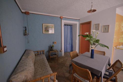 a living room with a table and a dining room at Palazzo Jannoni Holiday in SantʼAndrea Apostolo dello Ionio