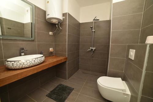 a bathroom with a toilet and a sink at Beachfront Marilyn in Durrës
