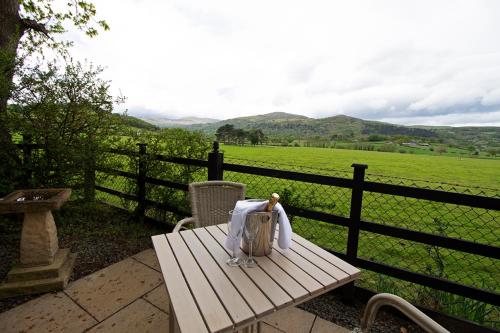 a wooden bench with a bag on top of a fence at The Groes Inn in Conwy