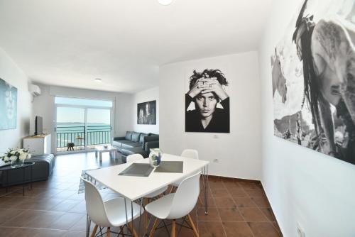 a living room with a white table and chairs at Beachfront Marilyn in Durrës