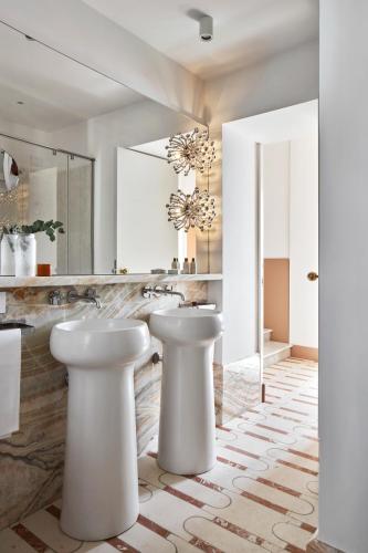 a bathroom with two sinks and a mirror at Palazzo Avino in Ravello