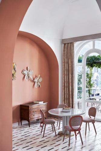 a dining room with a table and chairs at Palazzo Avino in Ravello