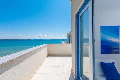 a balcony with a view of the ocean at Villa Miri in Privlaka
