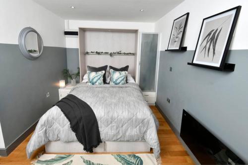 um quarto com uma cama grande e um espelho em Modern studio apartment in Leeds City Centre (LS1) em Leeds