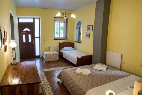 a room with two beds and a room with a door at Oasis in Preveza