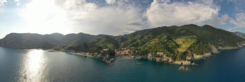 an island in the middle of a large body of water at Stella Della Marina in Monterosso al Mare