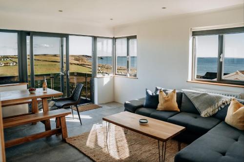 a living room with a couch and a table at Ty Melyn, Newgale in Newgale
