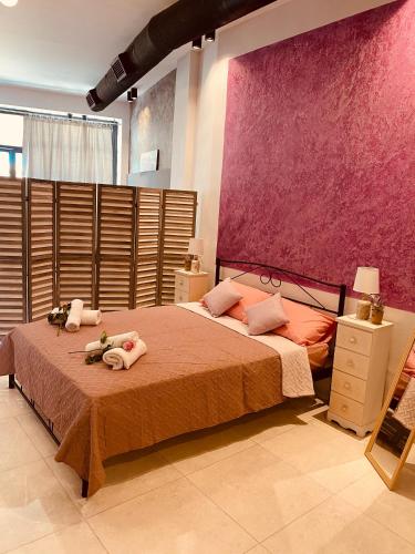 a bedroom with a bed with two stuffed animals on it at Corfu port apartment in Mantoúkion