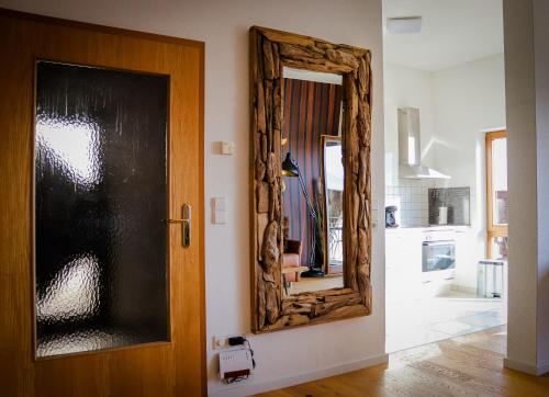 a mirror on a wall next to a door at See-Charme in Uhldingen-Mühlhofen