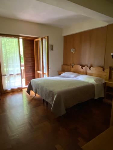 sypialnia z łóżkiem i dużym oknem w obiekcie Hotel Parco Erosa w mieście Abbadia San Salvatore