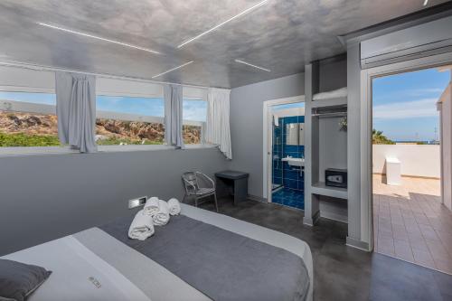 a bedroom with a bed and a view of the ocean at Rivazzurra Design Rooms in San Vito lo Capo
