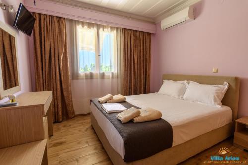 a bedroom with a bed with two towels on it at Villa Arion in Nydri