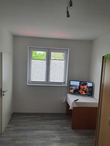 a room with a computer on a desk and a window at Gäste Haus Am See in Düren - Eifel