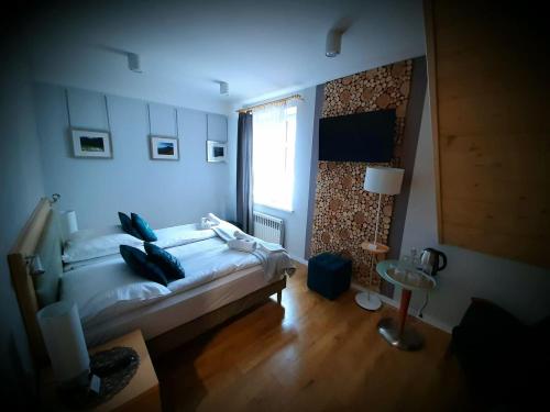 a bedroom with a large bed and a window at Dworek Zakopane in Zakopane