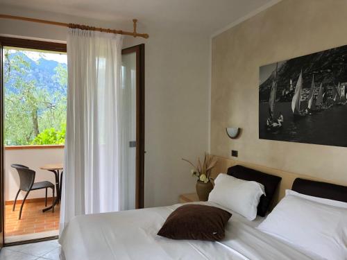 a bedroom with a bed and a table and a window at B&B Casa Benamati by Kelly in Malcesine