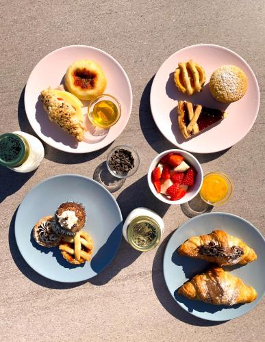 a group of plates of food on a table at Hotel Jolly Roger in Pietra Ligure